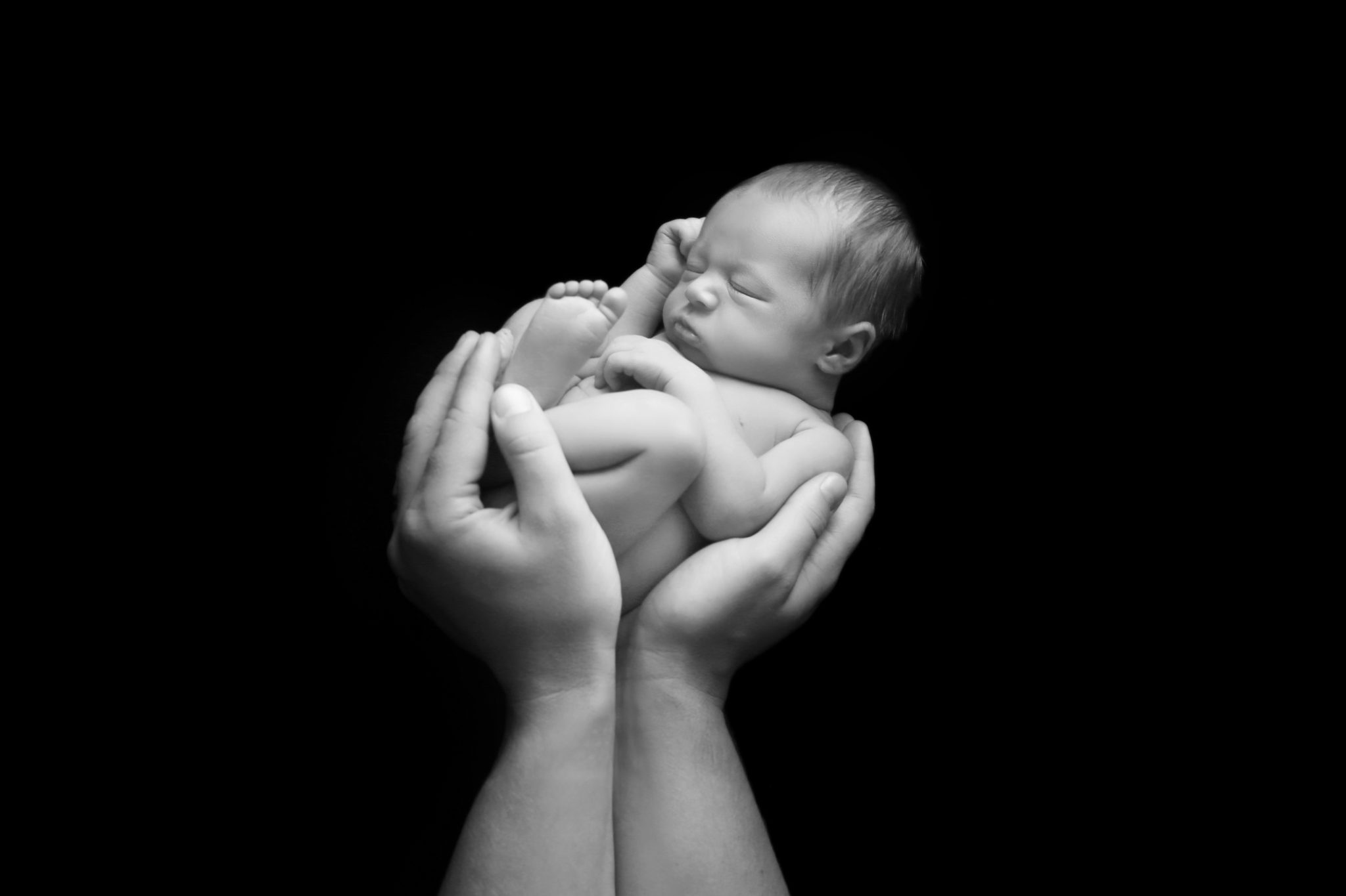 newborn asleep baby in daddy's hands east grinstead photographer