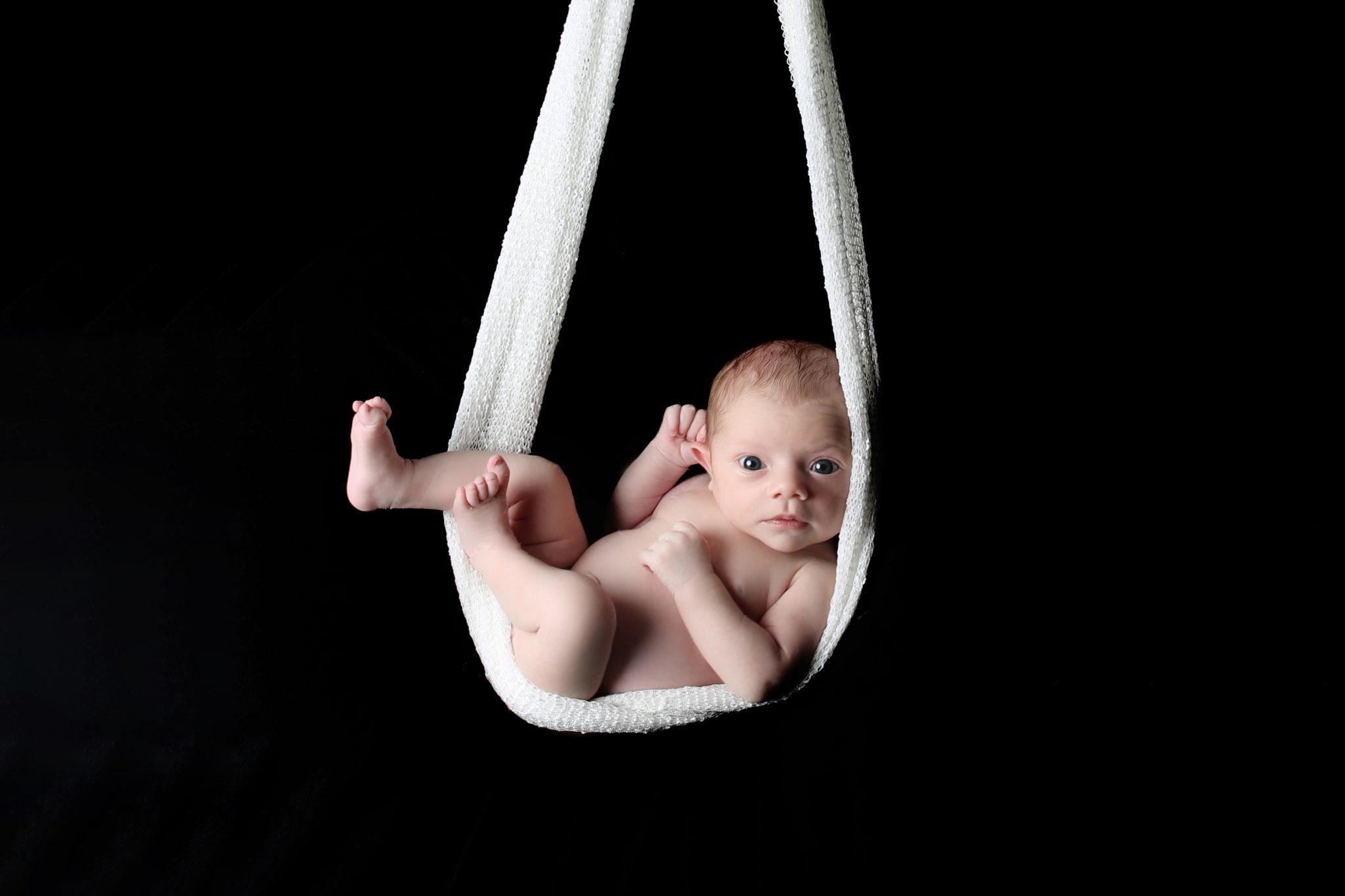 newborn photoshoot in west sussex newborn baby wide awake in hammock